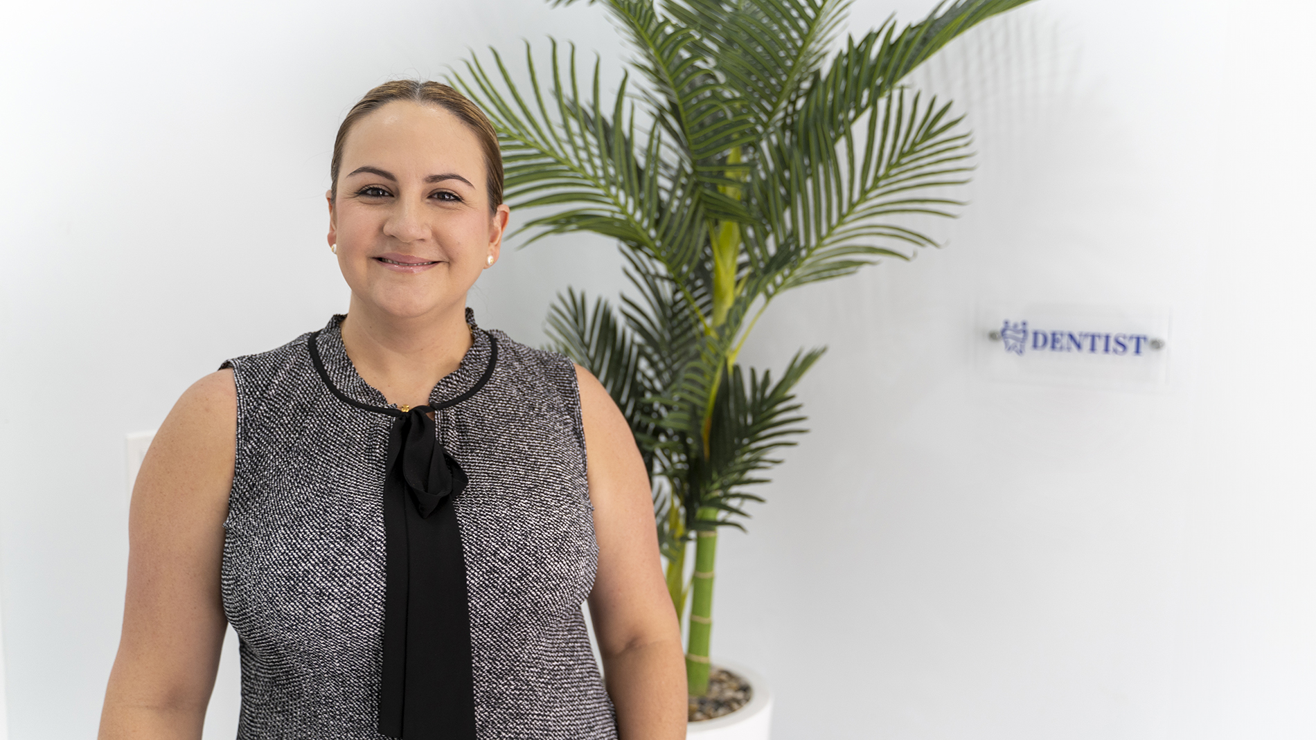 Dr. Gabriela Gil from EGil Dental, an expert in cosmetic bonding, smiling confidently.