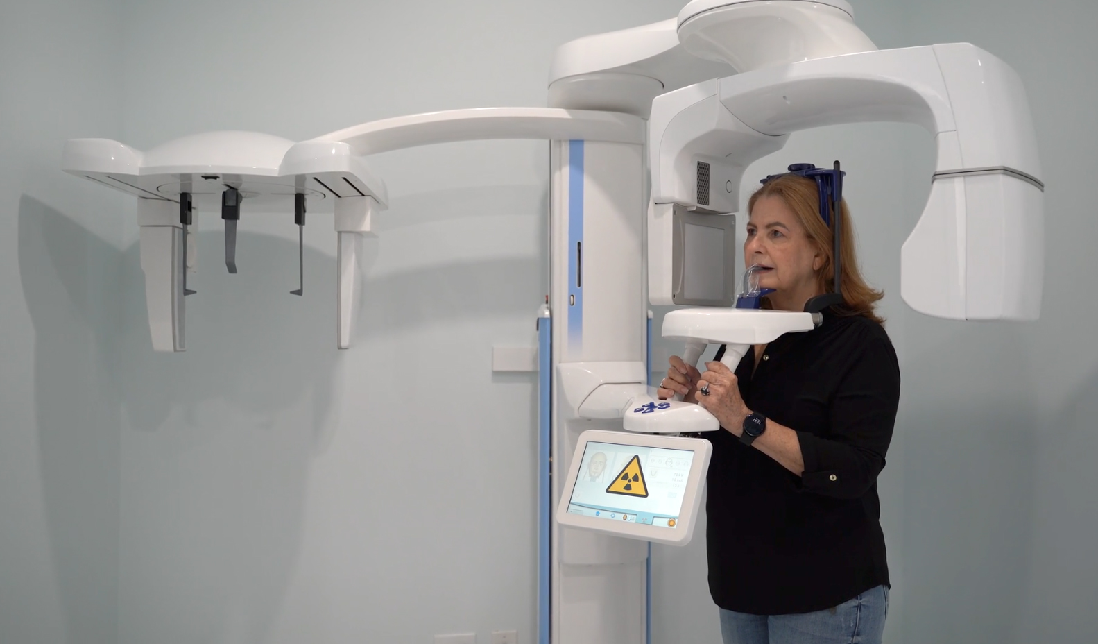 Woman receiving a panoramic digital dental x-ray at EGil Dental using advanced equipment.