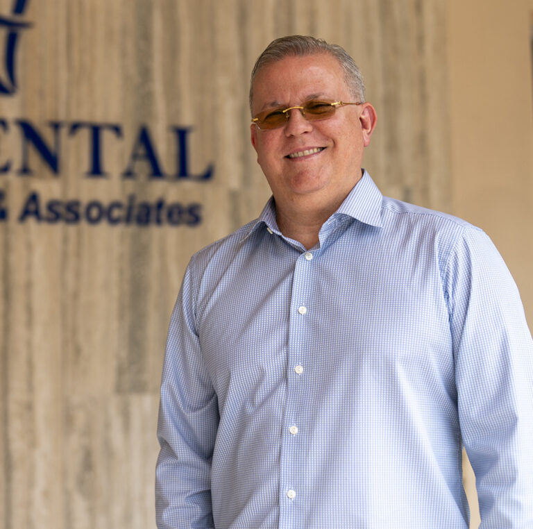 Dr. Eduardo Gil standing in front of EGil Dental clinic, representing innovation in dentistry.